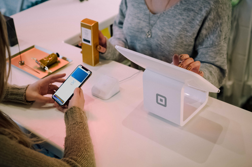 A person paying for their shopping using their mobile phone