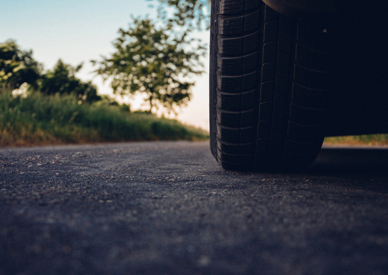 The wheel of a car stopped on the road