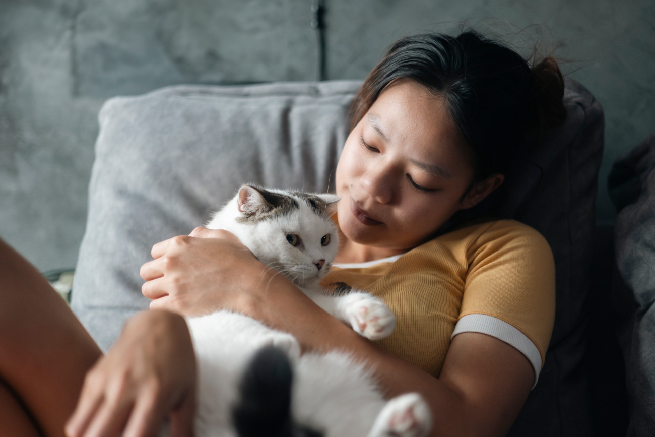 white cat and woman hugging